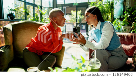 Phone, business women and discussion in cafe for idea, brainstorming or show eco friendly project online. Mobile, team meeting and planning in coffee shop for proposal with sustainability consultant 126149403