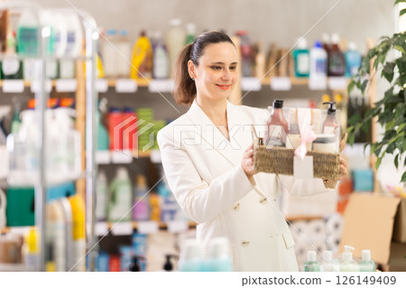 Adult woman buyer chooses cosmetics gift set Adult woman buyer chooses cosmetics gift set 126149409