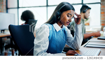 Burnout, headache and stress with woman in call center for assistance, feedback or problem solving. Computer, contact us and frustration with employee in workplace for customer service or support Burnout, headache and stress with woman in call center for assistance, feedback or problem solving. Computer, contact us and frustration with employee in workplace for customer service or support 126149439