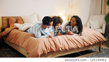 Bedroom, family and parents with child, tablet and watching movies on website, entertainment and online. Bonding, woman and man with son in home, streaming and smile for comedy film in apartment 126149462