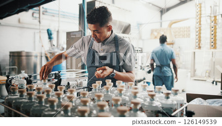 Distillery, worker and sealing bottle on conveyor belt for alcohol production process, packaging or distribution. Assembly line, man or cork spirits by machine for beverage storage or quality control Distillery, worker and sealing bottle on conveyor belt for alcohol production process, packaging or distribution. Assembly line, man or cork spirits by machine for beverage storage or quality control 126149539