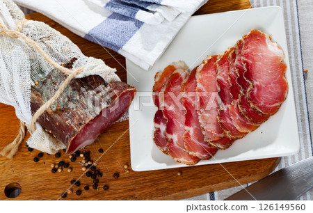 Slices of cured pork tenderloin on cutting board Slices of cured pork tenderloin on cutting board 126149560