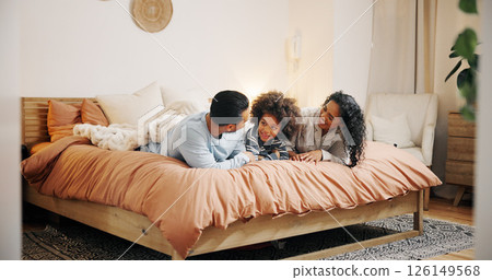 Bedroom, parents and bonding with child, smile and talking to boy in home, relax and family with love. Morning, man and woman with kid in house, mom and dad with care for son, conversation or happy Bedroom, parents and bonding with child, smile and talking to boy in home, relax and family with love. Morning, man and woman with kid in house, mom and dad with care for son, conversation or happy 126149568