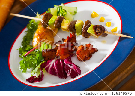 Chicken hearts with avocado on skewers with vegetables and fried chanterelles Chicken hearts with avocado on skewers with vegetables and fried chanterelles 126149579