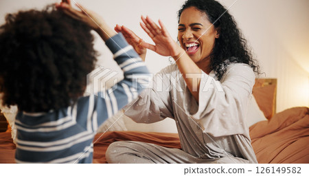 Smile, mom and high five for child, bedroom and excited for fun in house, laughing and game with kid. Happiness, woman and playing with son in home, boy and bonding with mother in apartment or family 126149582