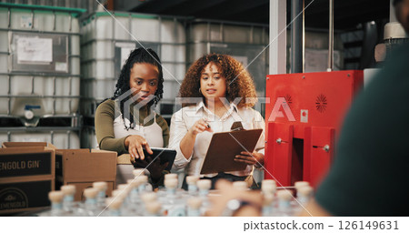 Distillery, check and inspection with women in factory for packaging, drink production and bottle checklist. Manufacturing, inventory and distribution with people in warehouse for quality control 126149631