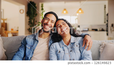 Happy couple, relax and laughing with hug on sofa for comedy, holiday or weekend at home. Man, woman or lovers with smile on couch for funny joke, humor or fun living room entertainment at house 126149823
