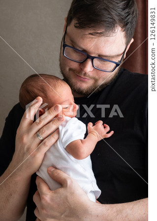 Man Holding Newborn Baby in Tender Moment 126149831
