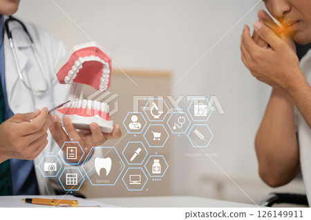 Dentist working tooth model, dentistry and recommend patient concept. Dentist working tooth model, dentistry and recommend patient concept. 126149911