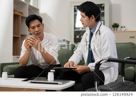 Concerned male patient, patient talks with healthcare professional and signing medical paper at appointment visit in clinic. 126149924