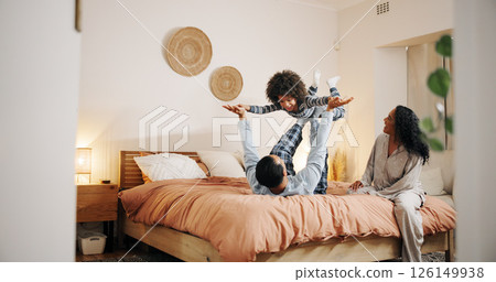 Airplane, child and playing with dad, bedroom and bonding with parents in home, love and happiness. Family, together and fun with son in apartment, morning and balance of boy for games or flying 126149938