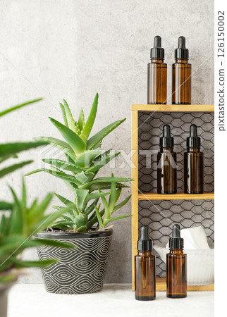 Brown light-blocking glass cosmetic bottles lined up on a shelf Brown light-blocking glass cosmetic bottles lined up on a shelf 126150002