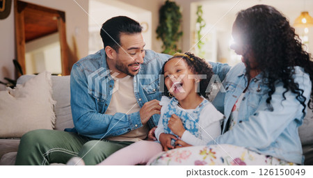Parents, girl and tickle on couch, laugh and bonding with love, comic joke and relax in lounge at family house. People, mother and father with child, care and funny games in living room at apartment 126150049