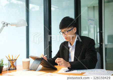 Business consultant analyzing financial data and investment plans 126150429