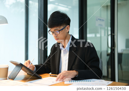 Business consultant analyzing financial data and investment plans 126150430