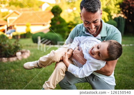 Joyful moments of laughter in a sunny backyard 126150540