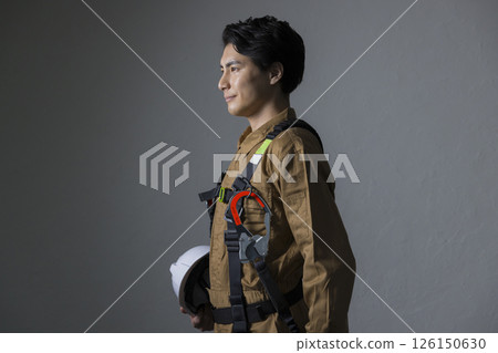 Male worker wearing a full harness 126150630