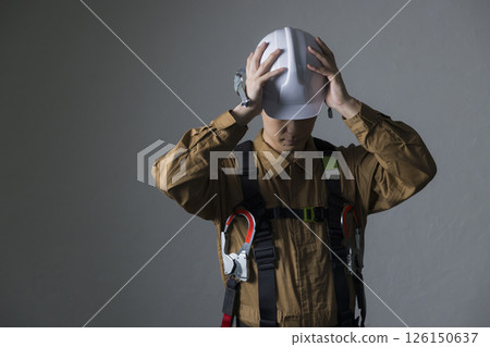 Male worker wearing a full harness Male worker wearing a full harness 126150637