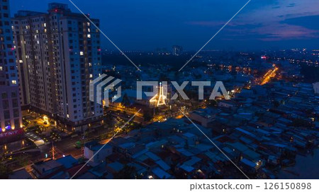 Aerial view of illuminated church by river surrounded by high rise residential buildings and city streets during blue hour with urban skyline and canal cityscape at twilight. High quality photo Aerial view of illuminated church by river surrounded by high rise residential buildings and city streets during blue hour with urban skyline and canal cityscape at twilight. High quality photo 126150898
