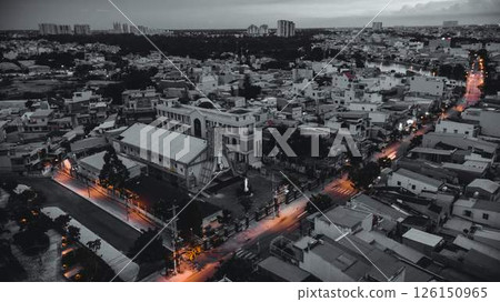Aerial view of illuminated church by river surrounded by high rise residential buildings and city streets during blue hour with urban skyline and canal cityscape at twilight. High quality photo Aerial view of illuminated church by river surrounded by high rise residential buildings and city streets during blue hour with urban skyline and canal cityscape at twilight. High quality photo 126150965