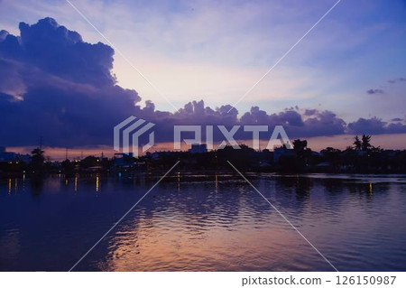 Towering cumulus clouds glowing in golden sunlight against clear blue sky at sunset with dramatic natural cloudscape and atmospheric light. High quality photo Towering cumulus clouds glowing in golden sunlight against clear blue sky at sunset with dramatic natural cloudscape and atmospheric light. High quality photo 126150987