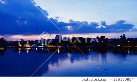 Towering cumulus clouds glowing in golden sunlight against clear blue sky at sunset with dramatic natural cloudscape and atmospheric light. High quality photo Towering cumulus clouds glowing in golden sunlight against clear blue sky at sunset with dramatic natural cloudscape and atmospheric light. High quality photo 126150994