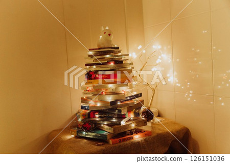 Christmas Tree with Book and Nativity Scene Festive Holiday Decorations and Cozy Seasonal Atmosphere. High quality photo Christmas Tree with Book and Nativity Scene Festive Holiday Decorations and Cozy Seasonal Atmosphere. High quality photo 126151036