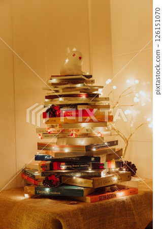 Christmas Tree with Book and Nativity Scene Festive Holiday Decorations and Cozy Seasonal Atmosphere. High quality photo 126151070