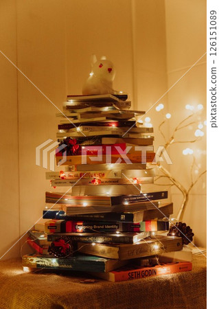 Christmas Tree with Book and Nativity Scene Festive Holiday Decorations and Cozy Seasonal Atmosphere. High quality photo Christmas Tree with Book and Nativity Scene Festive Holiday Decorations and Cozy Seasonal Atmosphere. High quality photo 126151089