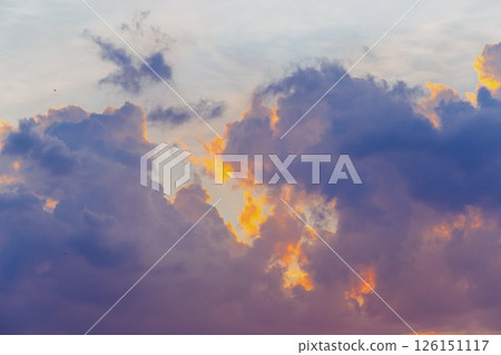 Towering cumulus clouds glowing in golden sunlight against clear blue sky at sunset with dramatic natural cloudscape and atmospheric light. High quality photo Towering cumulus clouds glowing in golden sunlight against clear blue sky at sunset with dramatic natural cloudscape and atmospheric light. High quality photo 126151117