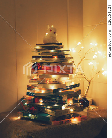 Christmas Tree with Book and Nativity Scene Festive Holiday Decorations and Cozy Seasonal Atmosphere. High quality photo 126151123