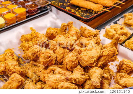 deep fried chicken legs in batter on street food market, selective focus deep fried chicken legs in batter on street food market, selective focus 126151140