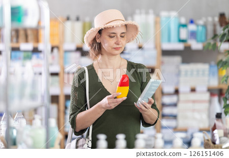 Woman buyer select sunscreen cream Woman buyer select sunscreen cream 126151406