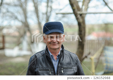 A gray-haired man on the street. Pensioner smiling on the street 126152088