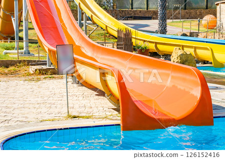 orange color waterslide at aquapark outdoor pool 126152416