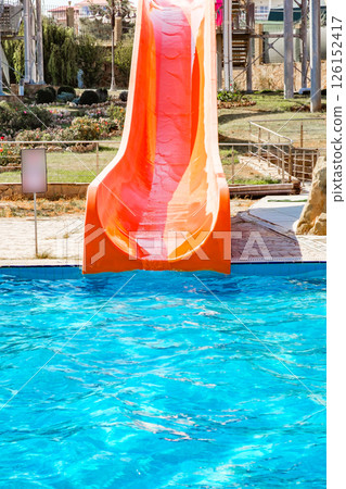 Pool with red water slide in aquapark Pool with red water slide in aquapark 126152417