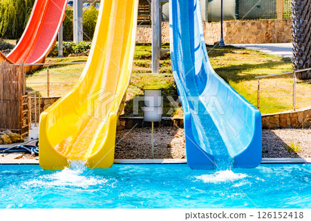 front view on blue and yellow waterslide at aquapark outdoor pool front view on blue and yellow waterslide at aquapark outdoor pool 126152418