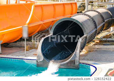 water flows down black water slide in water park water flows down black water slide in water park 126152422