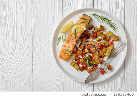 Oven-baked salmon fillet with fried potato, lemon Oven-baked salmon fillet with fried potato, lemon 126152466