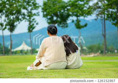 Happy mother and daughter spending time together in a park during spring. Happy mother and daughter spending time together in a park during spring. 126152867