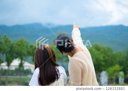 Happy mother and daughter spending time together in a park during spring. 126152881