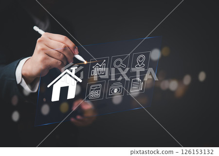 Modern digital interface showing real estate elements with businessman hand pointing stylus pen at house icon virtual screen financial analysis dashboard property technology 126153132