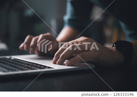 Close-up of hands typing on a laptop keyboard, representing remote work, technology, and digital communication in a modern workspace. 126153146