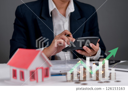 Mortgage and real estate finance concept with businessman using calculator. Homeownership planning, financial management, property loans, real estate growth, and investment strategies. Mortgage and real estate finance concept with businessman using calculator. Homeownership planning, financial management, property loans, real estate growth, and investment strategies. 126153163