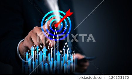 Businessman pointing at a virtual target with an arrow, business success, strategy, and goal achievement. Futuristic interface with rising arrows represents growth, leadership, and financial progress. 126153170