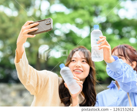 Women taking photos to commemorate their trip Women taking photos to commemorate their trip 126153262