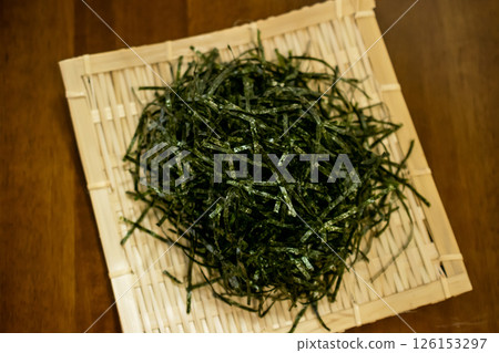 Close-up of shredded nori on a bamboo plate Close-up of shredded nori on a bamboo plate 126153297
