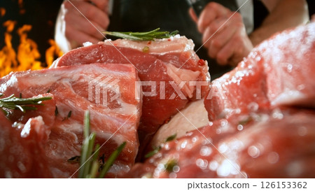 Large assortment of premium raw meat, beef, sausages, pork and chicken suitable for butchery advertising, fire on background 126153362
