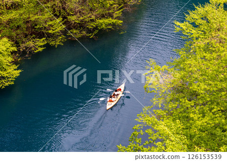 People enjoying canoeing on Lake Okushima in early summer 126153539