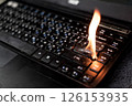 The computer laptop is burning with flames 126153935